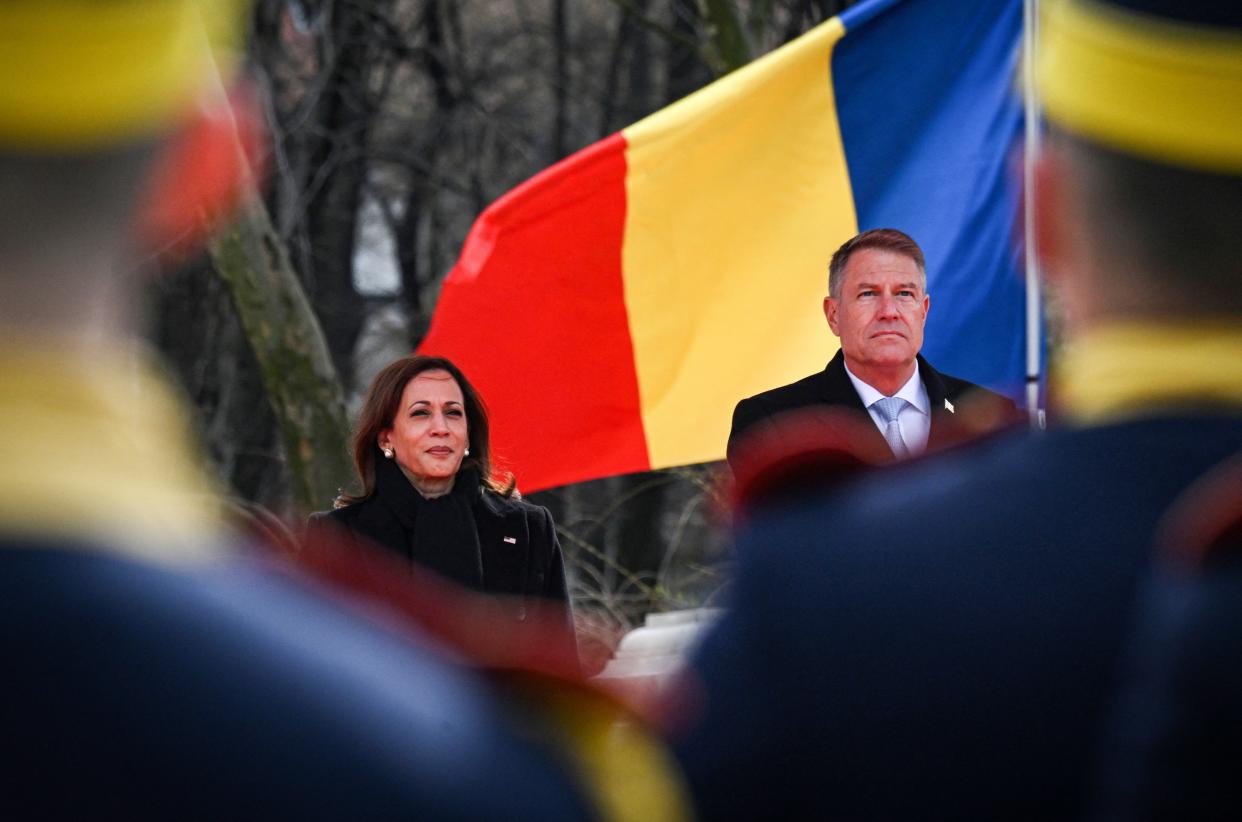 Romanian President Klaus Iohannis greets US Vice President Kamala Harris as they attend a welcoming ceremony at Cotroceni Palace, the Romanian Presidency headquarters, in Bucharest, Romania, March 11, 2022. 