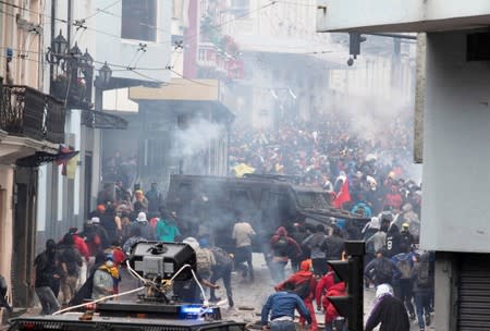 Demonstrators clash with riot police during protests after Ecuador's President Lenin Moreno's government ended four-decade-old fuel subsidies, in Quito