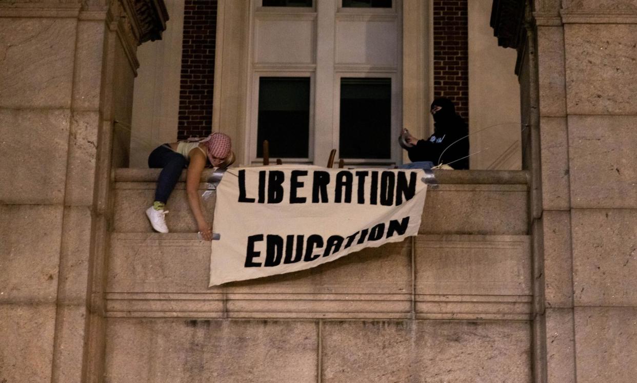 <span>Demonstrators from the pro-Palestine encampment on Columbia University campus unfurl a banner as they barricade themselves inside Hamilton Hall.</span><span>Photograph: Alex Kent/Getty Images</span>