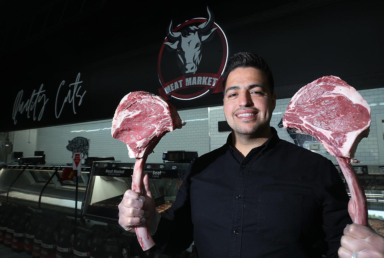 Fernando Alcauter, owner of Toro Meat Market, holds two tomahawks of beef. The market, which is located in the former Carfagna's Market, opened May 1. The market is open seven days a week from 9 a.m.-9 p.m.