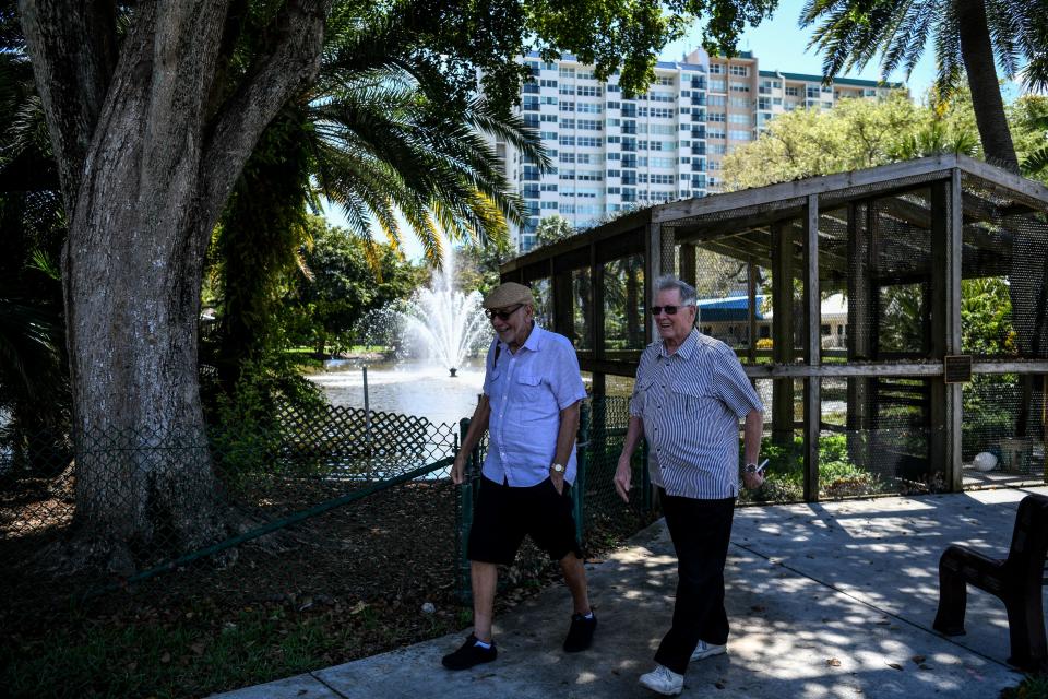 Elderly men walk inside deserted John Knox Village, a retirement community in Pompano Beach, Florida on March 21, 2020. - Almost one billion people were confined to their homes worldwide as the global coronavirus death toll topped 12,000 and US states rolled out stay-at-home measures already imposed across swathes of Europe. More than a third of Americans were adjusting to life in various phases of virtual lockdown -- including in the US's three biggest cities of New York, Los Angeles and Chicago -- with more states expected to ramp up restrictions. (Photo by CHANDAN KHANNA / AFP) (Photo by CHANDAN KHANNA/AFP via Getty Images)
