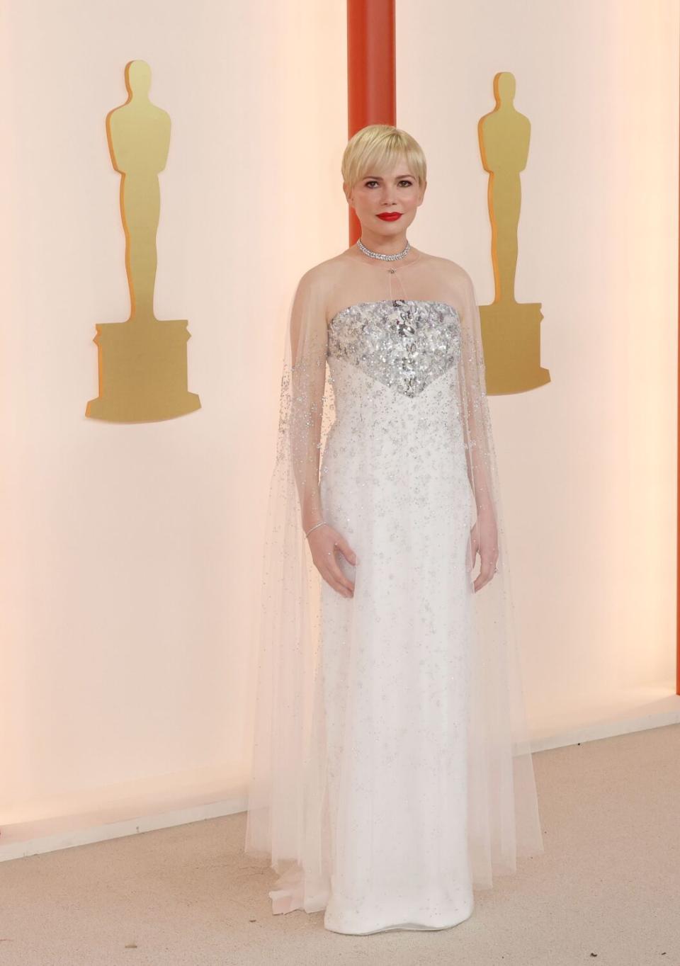 Michelle Williams in a gown with silvery, sparkling bustline and diaphanous white skirt.