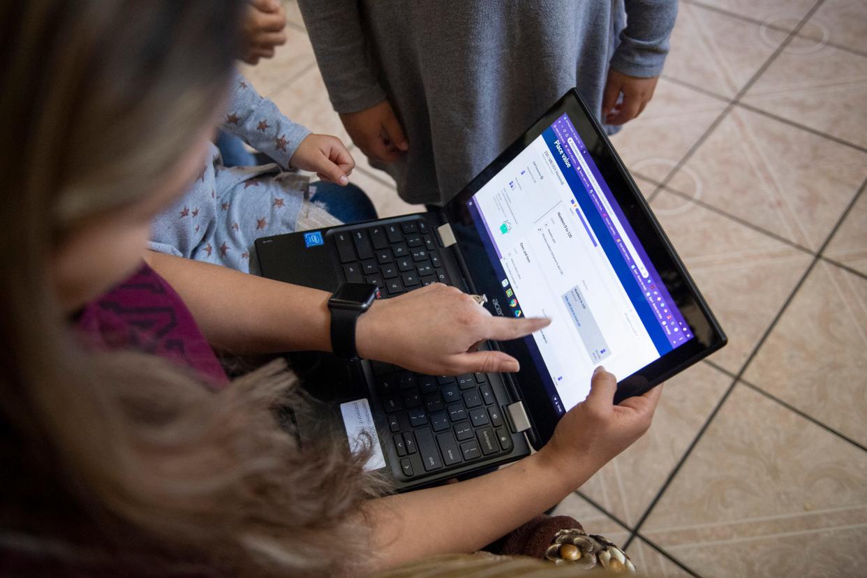 Rosa Picazo helps her daughter through a school problem early in the morning on Thursday, April 2, 2020.