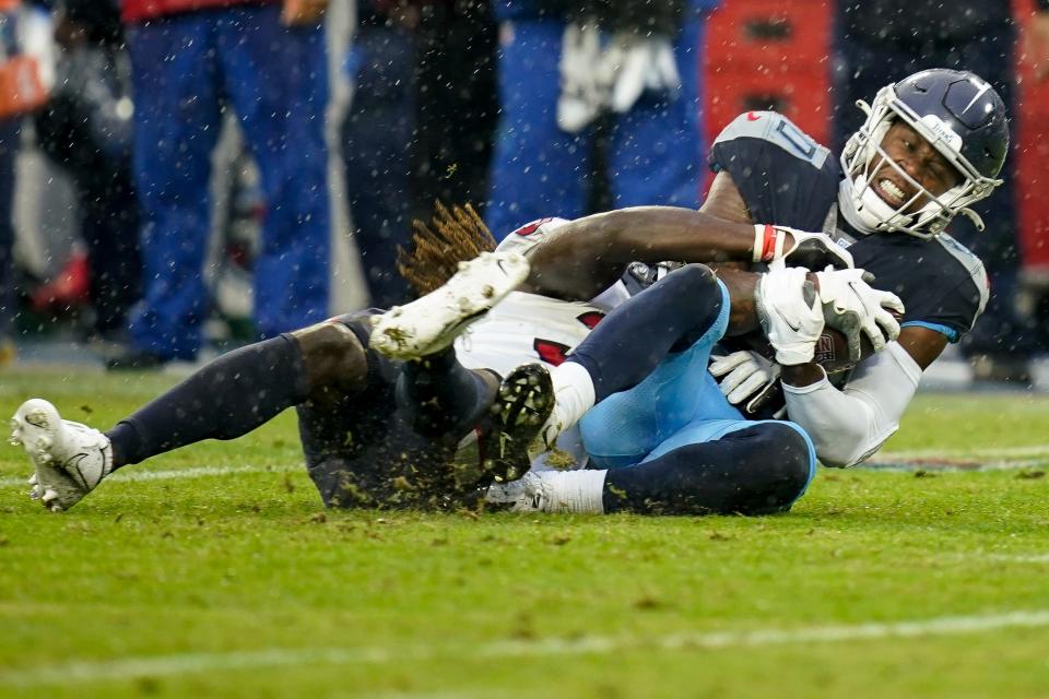 Tennessee Titans wide receiver Chester Rogers (80) is tackled by Houston Texans cornerback Tavierre Thomas (37) during the fourth quarter at Nissan Stadium in Nashville, Tenn., Sunday, Nov. 21, 2021.