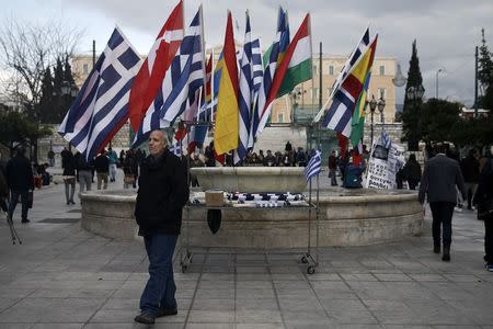 A man stands in front of his stall selling the national flags of European Union members on main Constitution (Syntagma) square in Athens February 28, 2015. REUTERS/Alkis Konstantinidis