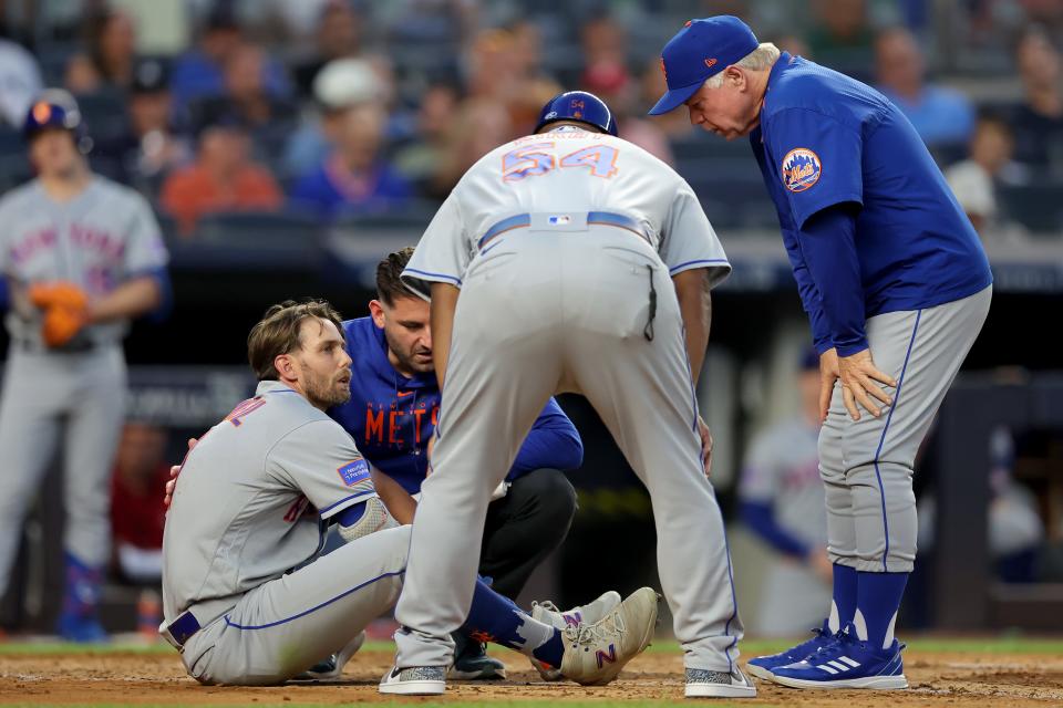 Jul 26, 2023; Bronx, New York, USA; New York Mets right fielder Jeff McNeil (1) is evaluated by manager Buck Showalter (11) and first base coach Wayne Kirby (54) after being hit by a pitch during the fourth inning against the New York Yankees at Yankee Stadium.