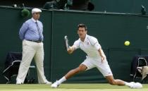 Novak Djokovic of Serbia plays a shot during his match against Philipp Kohlschreiber of Germany at the Wimbledon Tennis Championships in London, June 29, 2015. REUTERS/Suzanne Plunkett