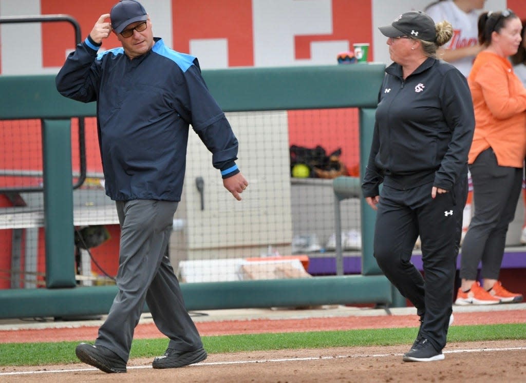 South Carolina softball coach Beverly Smith talks to first-base umpire Phillip Freels before Smith was ejected from Tuesday night's game.