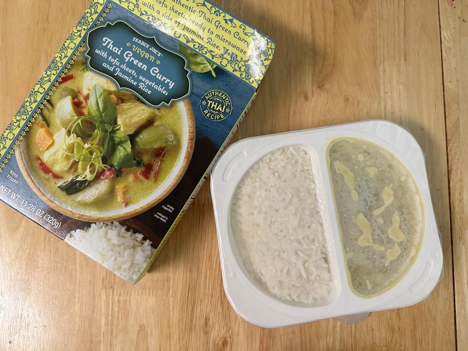 Trader Joe's vegan Thai green curry box next to tray of curry