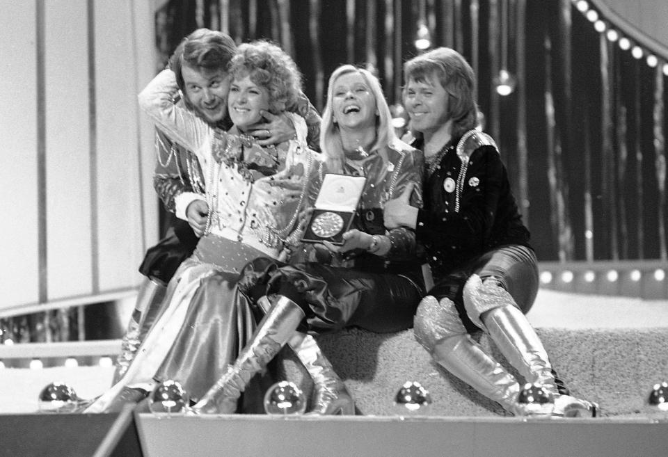 FILE - In this April 6, 1974 file photo, Swedish pop group ABBA celebrate winning the 1974 Eurovision Song Contest on stage at the Brighton Dome in England. From left are Benny Andersson, Anni-Frid Lyngstad (Frida), Agnetha Faltskog, and Bjorn Ulvaeus. In their song “One Last Summer,” they write the sentimental detail, “In the tourist jam, round the Notre-Dame/Our last summer/Walking hand in hand." (AP Photo/Robert Dear)