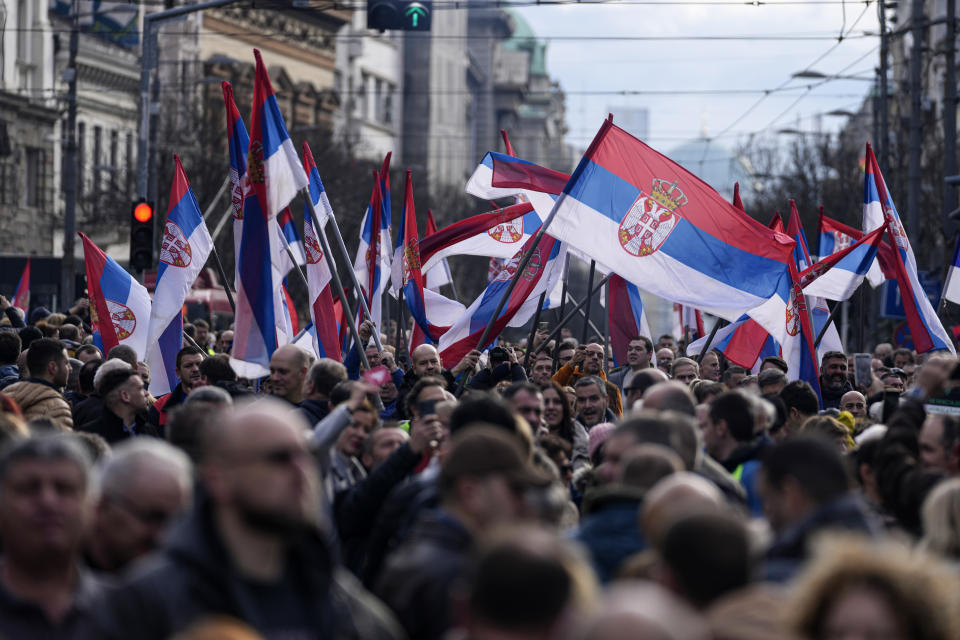 Protesters wave Serbian flags during a demonstration downtown Belgrade, Serbia, Saturday, Dec. 30, 2023. Thousands of people gathered to protest what election observers said were widespread vote irregularities during a recent general election. (AP Photo/Darko Vojinovic)