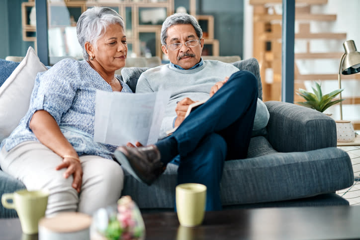 A senior couple reviewing how filing taxes jointly instead of separately will change what they owe in taxes.