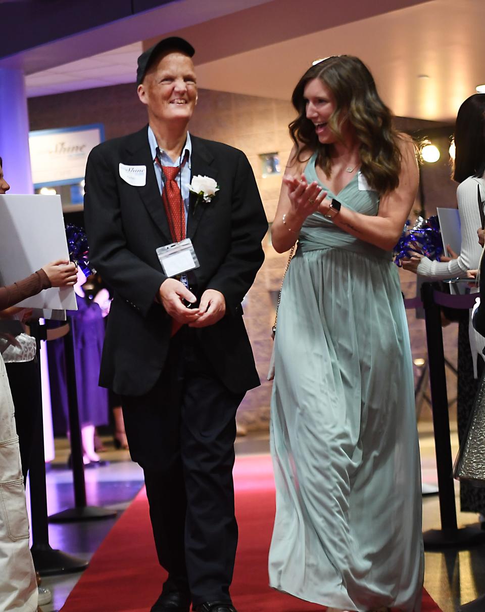 First Baptist Spartanburg joined with the Tim Tebow Foundation to host its annual 'Night to Shine Prom' event for adults with special needs. The event was held at the 'Hangar' in downtown Spartanburg on Feb. 9, 2024. Here, the guests and their escorts 'buddies' walk the Red Carpet. Here, Peter Brown, left, enters the Prom.