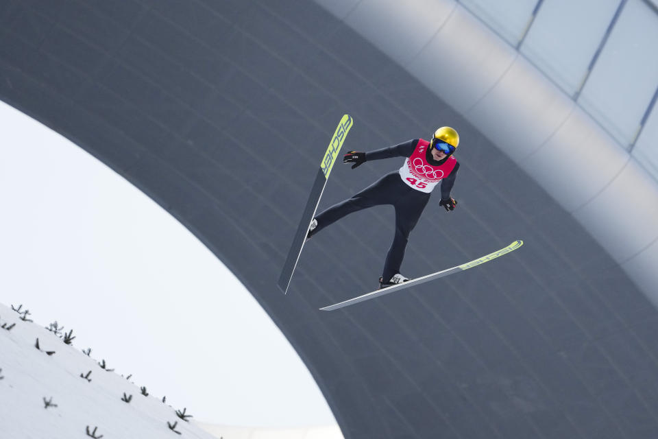 Vinzenz Geiger, of Germany, soars through the air during a trial round in the ski jump portion of the individual Gundersen normal hill event at the 2022 Winter Olympics, Wednesday, Feb. 9, 2022, in Zhangjiakou, China. (AP Photo/Matthias Schrader)