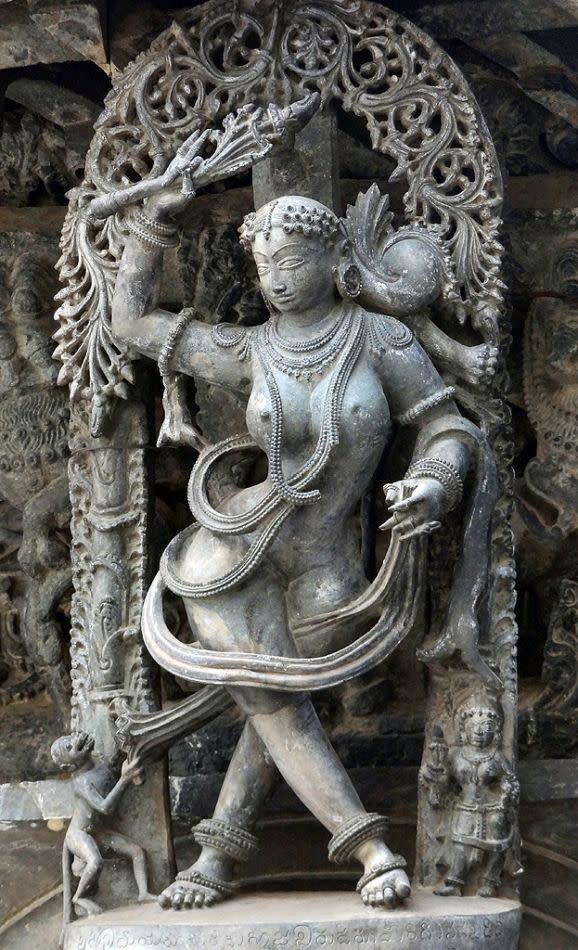 Here, a monkey is teasing the lady by pulling her sari. The lady is trying to shoo the monkey off by holding a tendril in her hand.