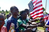 <p>Residents of Nyang’oma village in Kogelo wave US flags as they gather by the side of the road to wait for former US President, Barak Obama to arrive on July 16, 2018 for the opening of the Sauti Kuu Resource Centre, founded by his half-sister, Auma Obama at Kogelo in Siaya county, western Kenya. – Obama is in the East African nation for the first time since he left the US presidency and met with President Uhuru Kenyatta and opposition leader Raila Odinga in Nairobi. (Photo: Tony Karumba/AFP/Getty Images) </p>