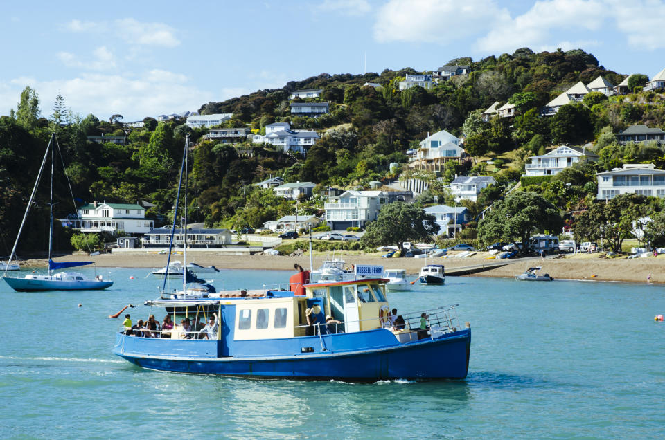 Vintage Paihia - Russell Passenger Ferry crossing Bay of Island's on a Summer day. The historic town of Russell and Flagstaff Hill in the background was New Zealand's first capital city.