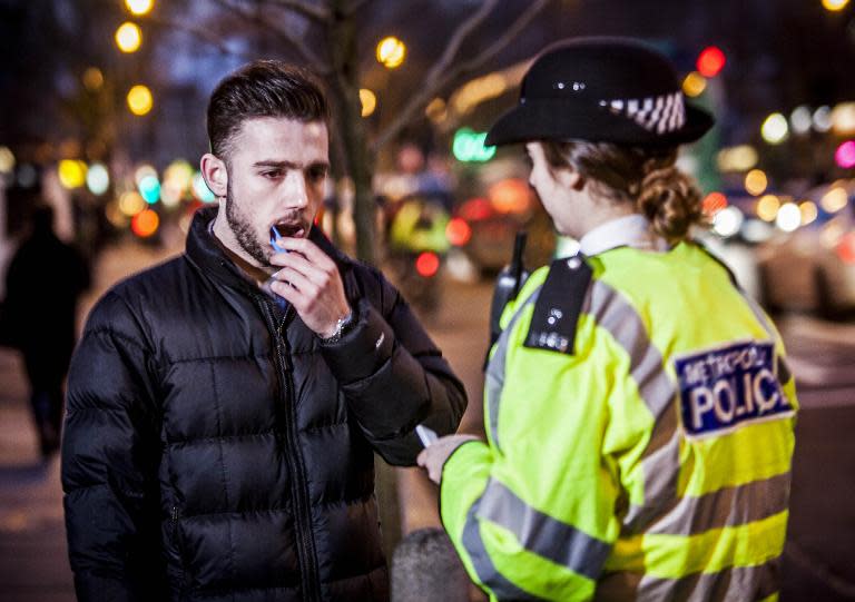 Photo released by the Department for Transport's THINK! campaign on March 2, 2015 shows an actor playing a motorist being tested for misuse of drugs by a police officer in London