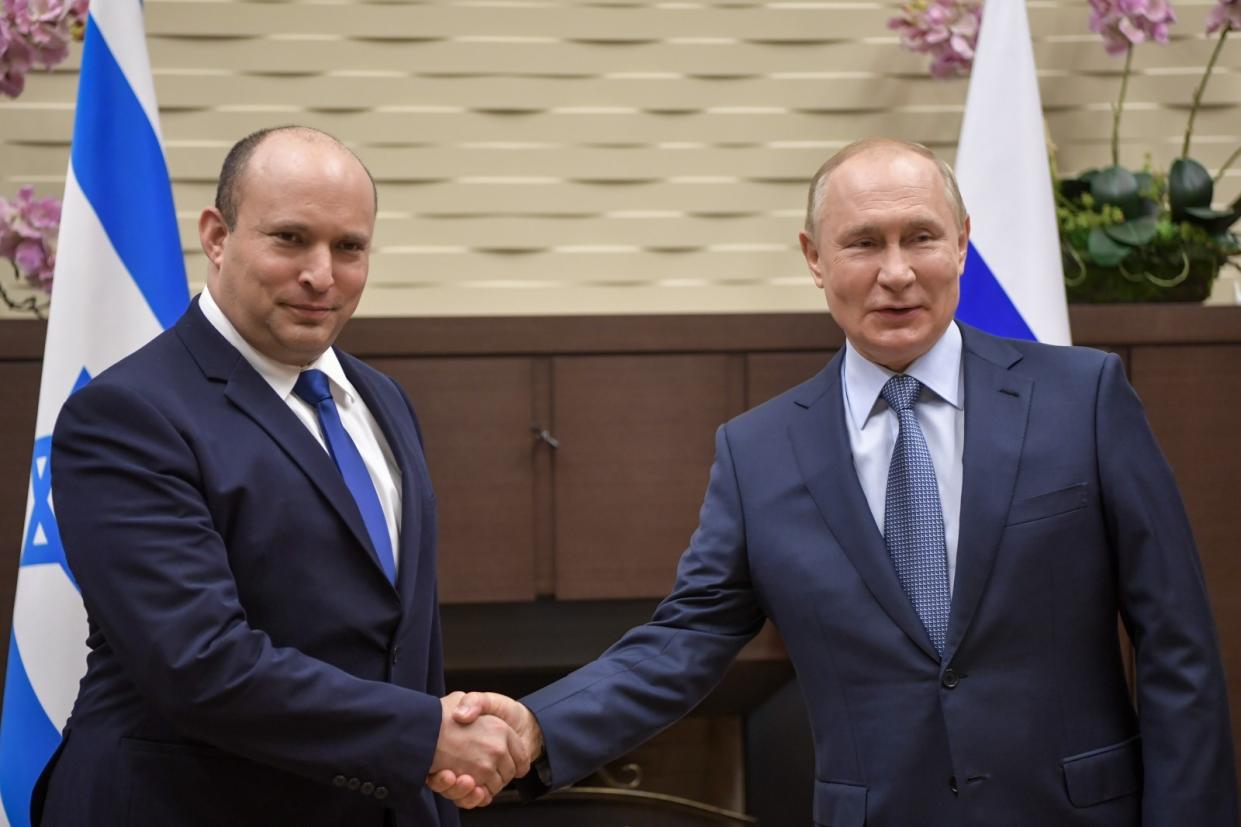 Israeli Prime Minister Naftali Bennett shakes hands with Russian President Vladimir Putin in Sochi, Russia, in 2021.
