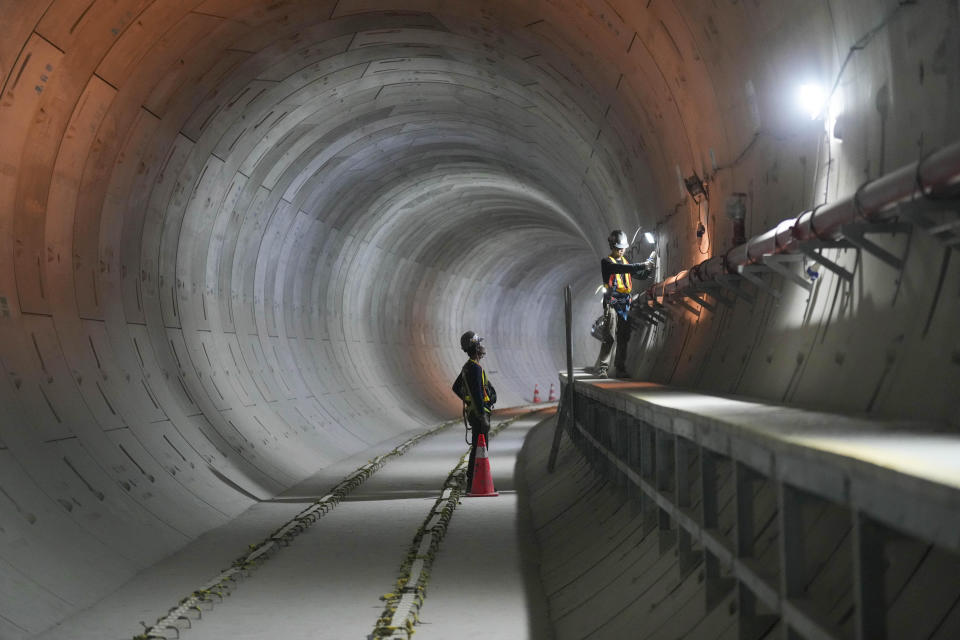 Men work inside a tunnel at a Mass Rapid Transit (MRT) construction site in Jakarta, Indonesia Thursday, Jan. 25, 2024. The construction of the second phase of the subway line aimed at staving off crippling traffic gridlock in the megacity is scheduled to be gradually completed. (AP Photo/Tatan Syuflana)