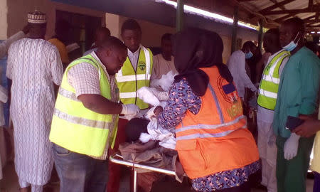 Rescuers help the casualties at the site of a suicide bomber attack in Mubi in Adamawa state, in northeastern Nigeria November 21, 2017. NEMA/Handout via REUTERS