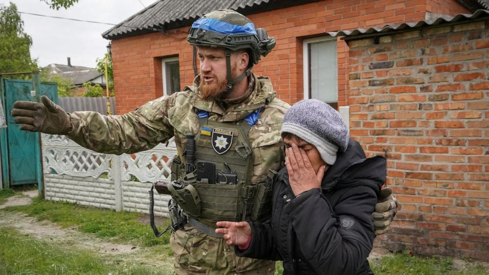 PHOTO: A police officer helps a local resident during an evacuation to Kharkiv due to Russian shelling, amid Russia's attack on Ukraine, in the town of Vovchansk in Kharkiv region, Ukraine, May 13, 2024. (Reuters)