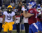 Kansas fullback Jared Casey (47) catches a pass for a touchdown against West Virginia's Scottie Young (19) during the second quarter of an NCAA college football game Saturday, Nov. 27, 2021, in Lawrence, Kan. (AP Photo/Ed Zurga)