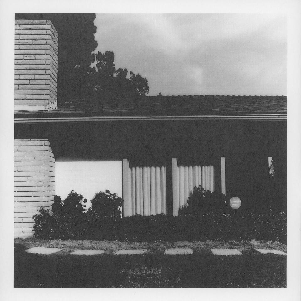 A black-and-white photo of a modernist house.
