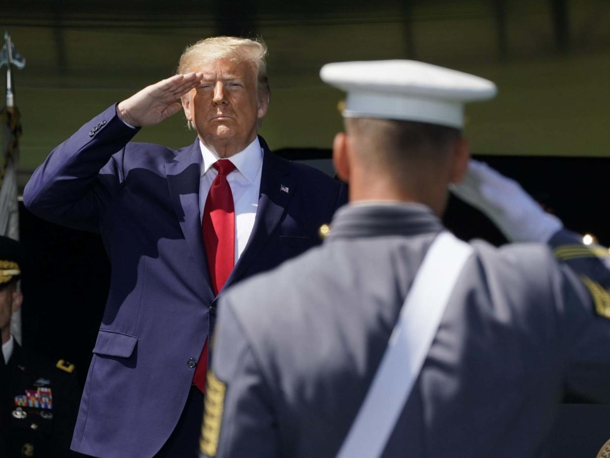 Donald Trump salutes as he arrives at West Point Military Academy (AFP via Getty Images)