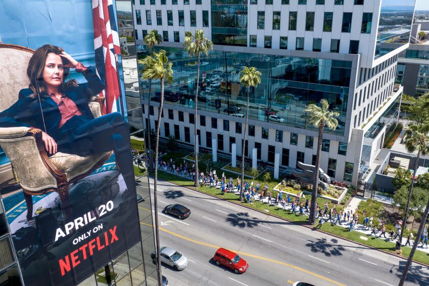 Hollywood, CA - May 02: A billboard for a Netflix streaming show "The Diplomat" on a building across the street where WGA members walk a picket line around the Bronson Sunset Studios lot where Netflix leases space for production and offices Tuesday, May 2, 2023 in Hollywood, CA. (Brian van der Brug / Los Angeles Times)