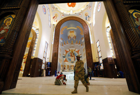 An army soldier walks near workers cleaning the interior of the new Coptic Cathedral of the Nativity in the New Administrative Capital (NAC) east of Cairo, Egypt January 3, 2019. Picture taken January 3, 2019. REUTERS/Amr Abdallah Dalsh