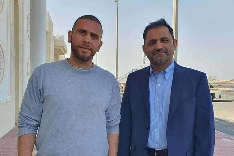 A handout image provided by Iran's Nournews Agency shows Mehrdad Moein Ansari (L) and Reza Sarhangpour, two Iranian nationals who were detained in the United States, after their arrival in Doha, Qatar, on Monday. They were released in a prisoner-swap deal with Iran. Photo by Nournews Agency