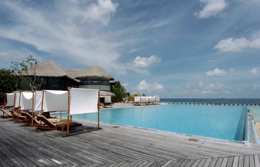 Tourists relax by a swimming pool adjoining the Indian Ocean at the plush Coco Palm resort on Boduhithi island, Maldives, in 2007. The Maldives' best-known blogger believes his attempted murder was linked to the political and social changes sweeping the Indian Ocean island nation, a "paradise" holiday destination of turquoise waters and coral-fringed beaches