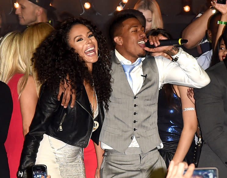 PHOENIX, AZ - JANUARY 31: Miss Guam Brittany Bell and actor/singer Nick Cannon (C) perform onstage during the Maxim Party with Johnnie Walker, Timex, Dodge, Hugo Boss, Dos Equis, Buffalo Jeans, Tabasco and popchips on January 31, 2015 in Phoenix, Arizona. (Photo by Jason Merritt/Getty Images for Maxim)