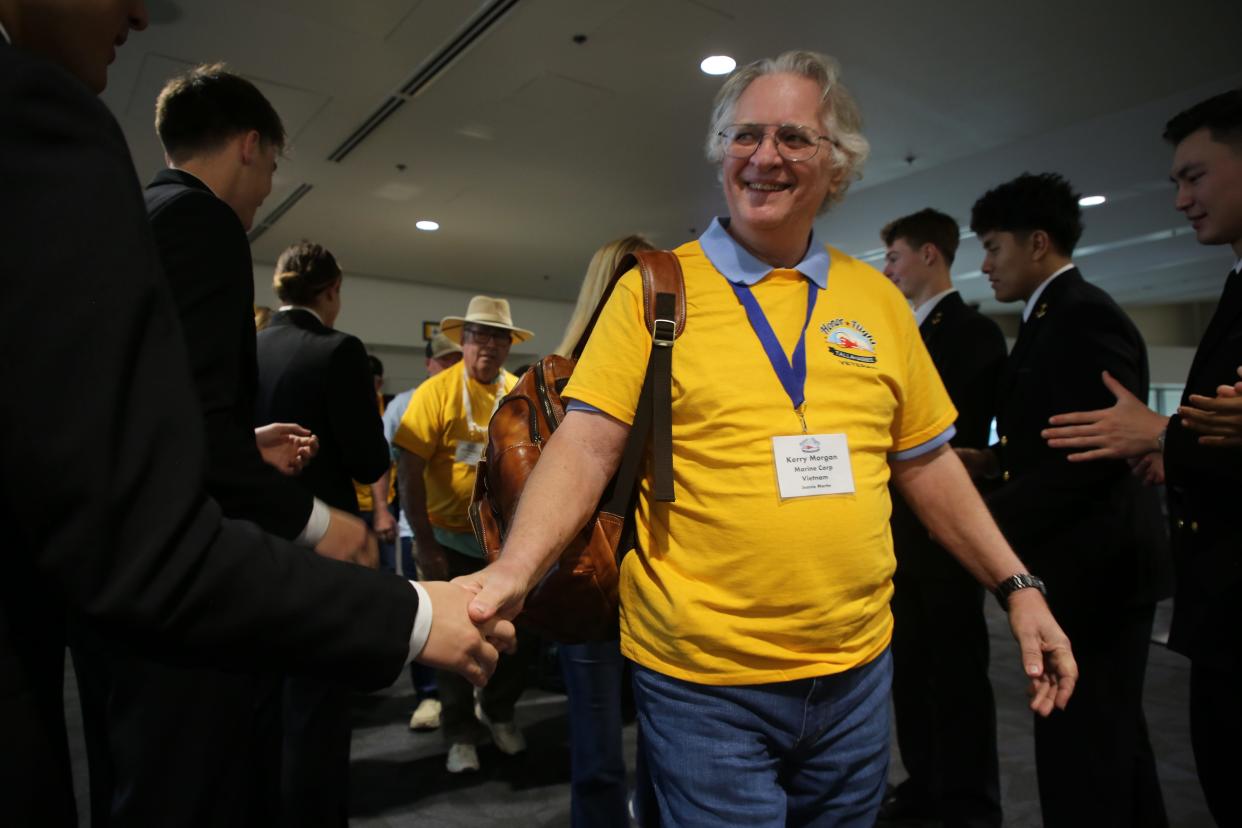 Kerry Morgan, a Vietnam War veteran who served in the Marin Corp, shakes hands with a Naval Academy student, April 27, 2024.