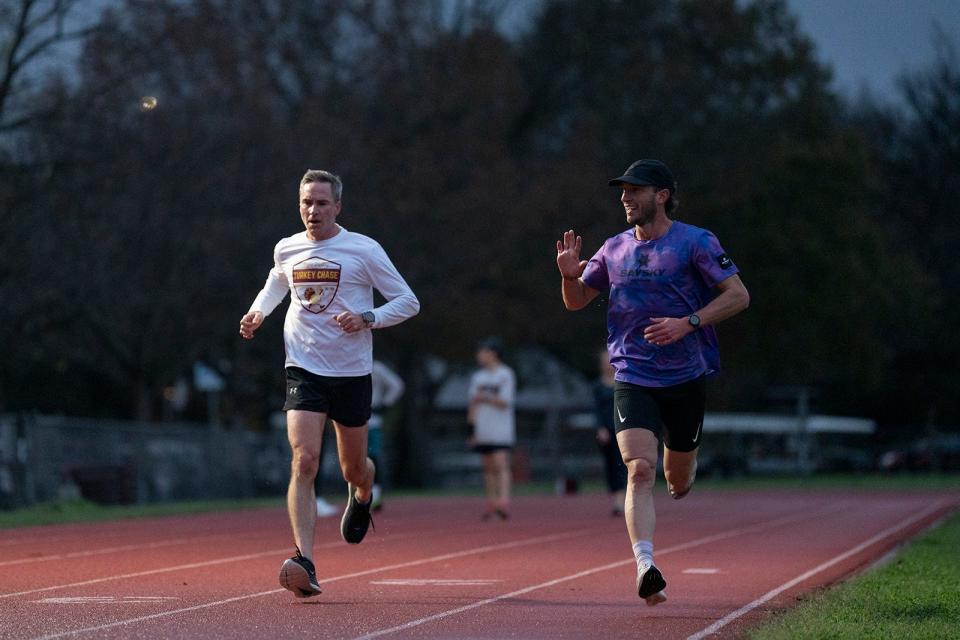 Mitch Ammons waves to a friend as he trains at Austin High on Tuesday. Ammons, a local runner recovering from drug addiction, "has the ability to work through discomfort and to endure pain," according to his coach Jeff Cunningham.