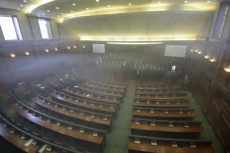 Opposition politicians release tear gas in parliament to obstruct a session in Pristina, Kosovo February 19, 2016. REUTERS/Agron Beqiri