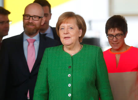 Secretary General of the Christian Democratic Union (CDU) Peter Tauber, German Chancellor Angela Merkel and Saarland State Prime Minister Annegret Kramp-Karrenbauer ahead CDU leadership meeting in Berlin, Germany, February 19, 2018. REUTERS/Hannibal Hanschke