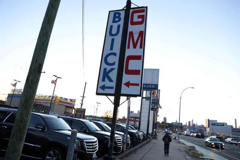 FILE PHOTO: Signs advertising Buick and GMC, brands owned by General Motors Company, are seen at a car dealership in Queens, New York