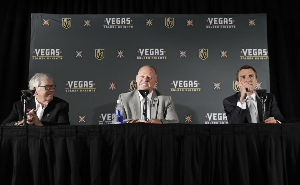 Gerard Gallant, center, speaks during a news conference with Bill Foley, left, owner of the Vegas Golden Knights, and George McPhee, Vegas Golden Knights general manager, Thursday, April 13, 2017, in Las Vegas. The Vegas Golden Knights have hired Gallant as the first coach of the NHL expansion team. (AP Photo/John Locher)