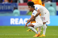 Qatar's Akram Afif embracers a teammate at the end of their 0-2 lost against Netherlands during a World Cup group A soccer match at the Al Bayt Stadium in Al Khor, Qatar, Tuesday, Nov. 29, 2022. (AP Photo/Petr David Josek)