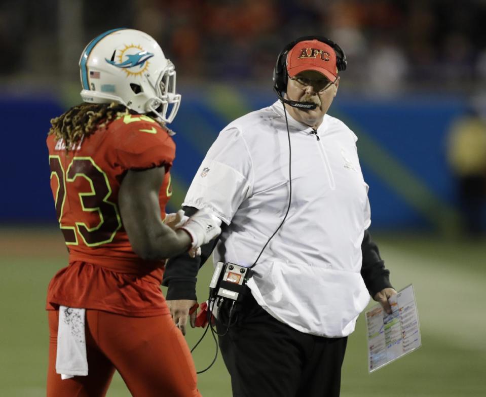 AFC head coach Andy Reid, of the Kansas City Chiefs, talks to AFC running back Jay Ajayi (23), of the Miami Dolphins, during the second half of the NFL Pro Bowl football game Sunday, Jan. 29, 2017, in Orlando, Fla. (AP Photo/Chris O'Meara)