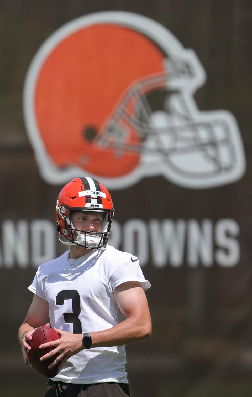 Cleveland Browns rookie kicker Cade York tosses around a football on the sidelines during the NFL football team's rookie minicamp in Berea on Friday.