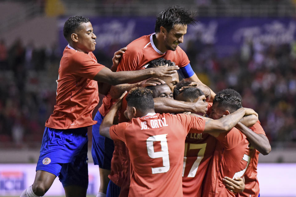 In this Sept. 6, 2019 photo, Costa Rica's Celso Borges is congratulated by teammates after scoring against Uruguay during a friendly soccer match at the National Stadium in San Jose, Costa Rica. (AP Photo/Carlos Gonzalez)