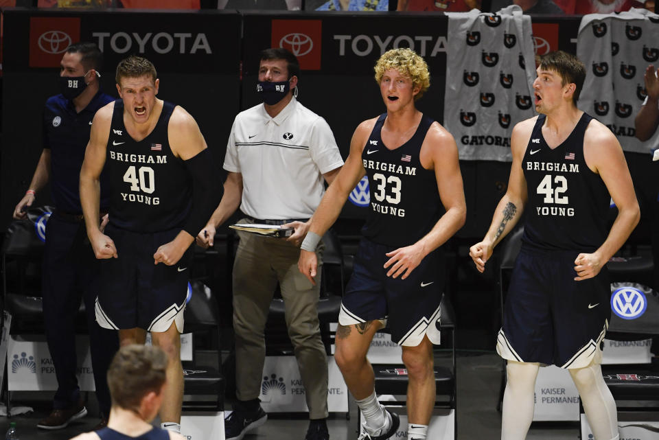 BYU players celebrate a three-point basket during the second half of an NCAA college basketball game against San Diego State, Friday, Dec. 18, 2020, in San Diego. (AP Photo/Denis Poroy)