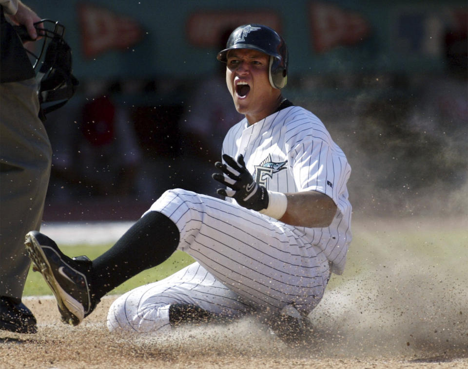 FILE - Florida Marlins' Miguel Cabrera celebrates as he slides home with the winning run on Juan Pierre's single in the ninth inning to give the Marlins a 7-6 win over the Philadelphia Phillies, July 27, 2003, in Miami. Cabrera, one of the greatest hitters of all time, is retiring after the Tigers wrap up their season Sunday, Oct. 1, 2023, and baseball’s last Triple Crown winner is leaving a lasting legacy in the game and his native Venezuela. (AP Photo/Richard Patterson, File)