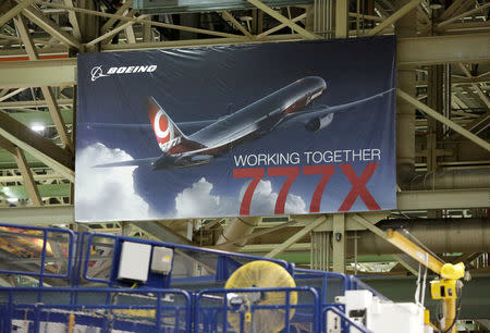 FILE PHOTO: A 777X banner is pictured above the 777 Wing Horizontal Build Line at Boeing's production facility in Everett, Washington, U.S. June 1, 2017. REUTERS/Jason Redmond/File Photo