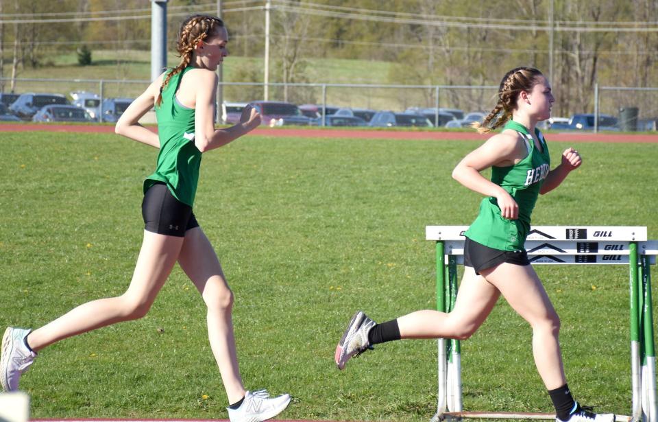 Herkimer Magician Cadence Weaver (right) leads teammate Sydney Bell down the stretch to the 800-meter finish line Monday.