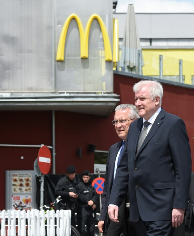 The conservative premier of Bavaria, Horst Seehofer (R) near the Olympia-Einkaufszentrum shopping centre on July 23, 2016 in Munich, a day after the shooting rampage