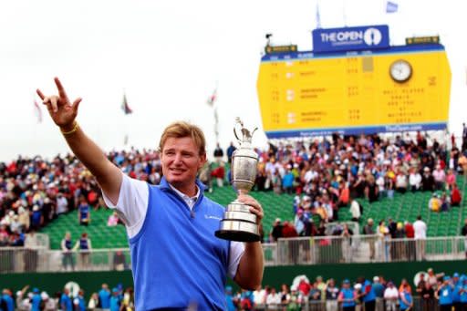 Ernie Els of South Africa holds the Claret Jug, 'The Golf Champion Trophy' in front of the scoreboard on the 18th green after winning the 2012 Open Championship at Royal Lytham and St Annes in Lytham. Els won the championship with a score of 273, one shot clear of Adam Scott of Australia